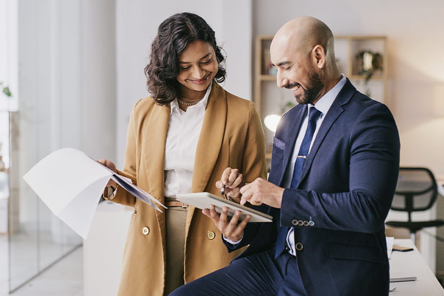 Two professionals collaborating on a tablet.
