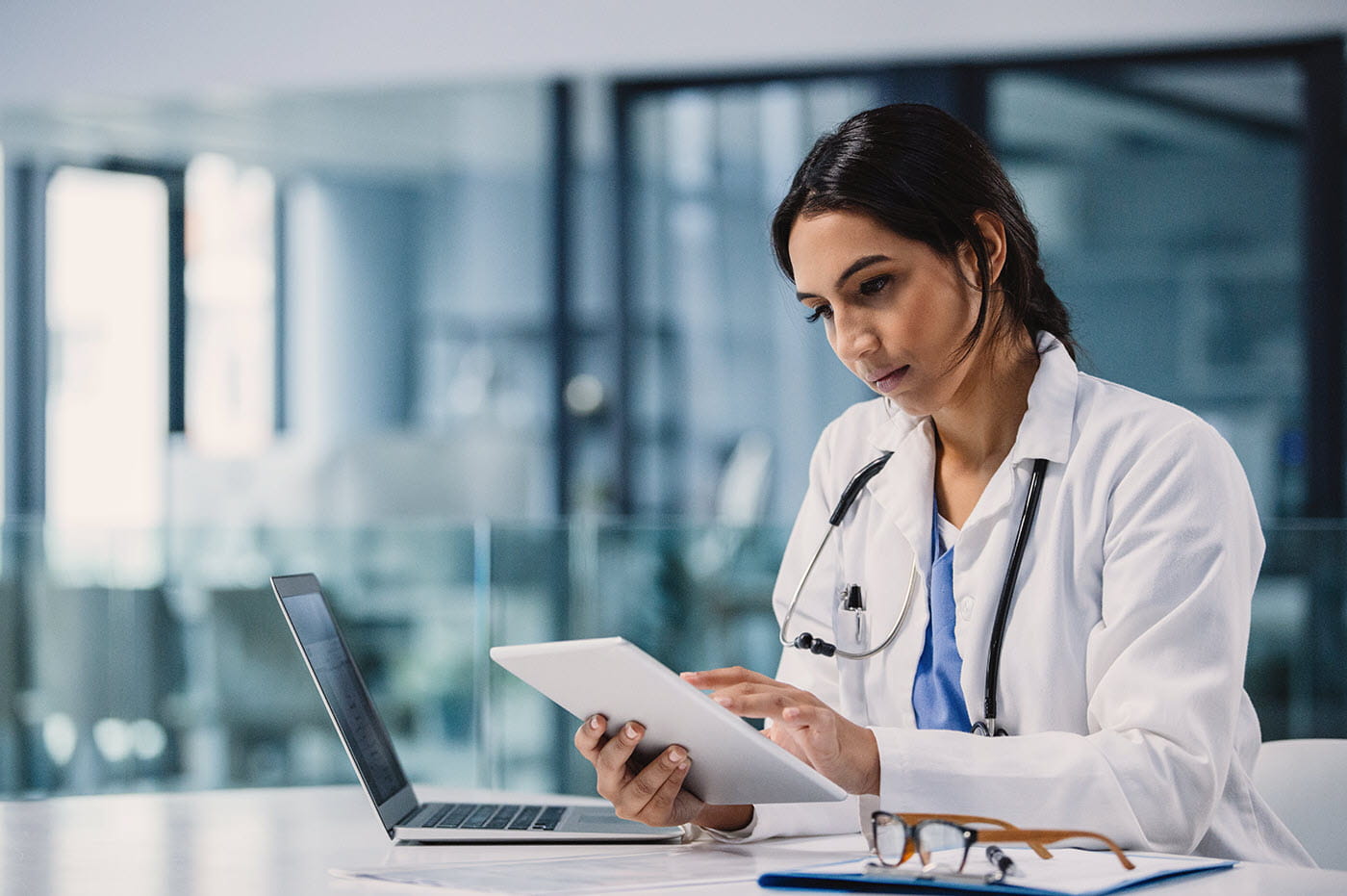 Female doctor working on tablet