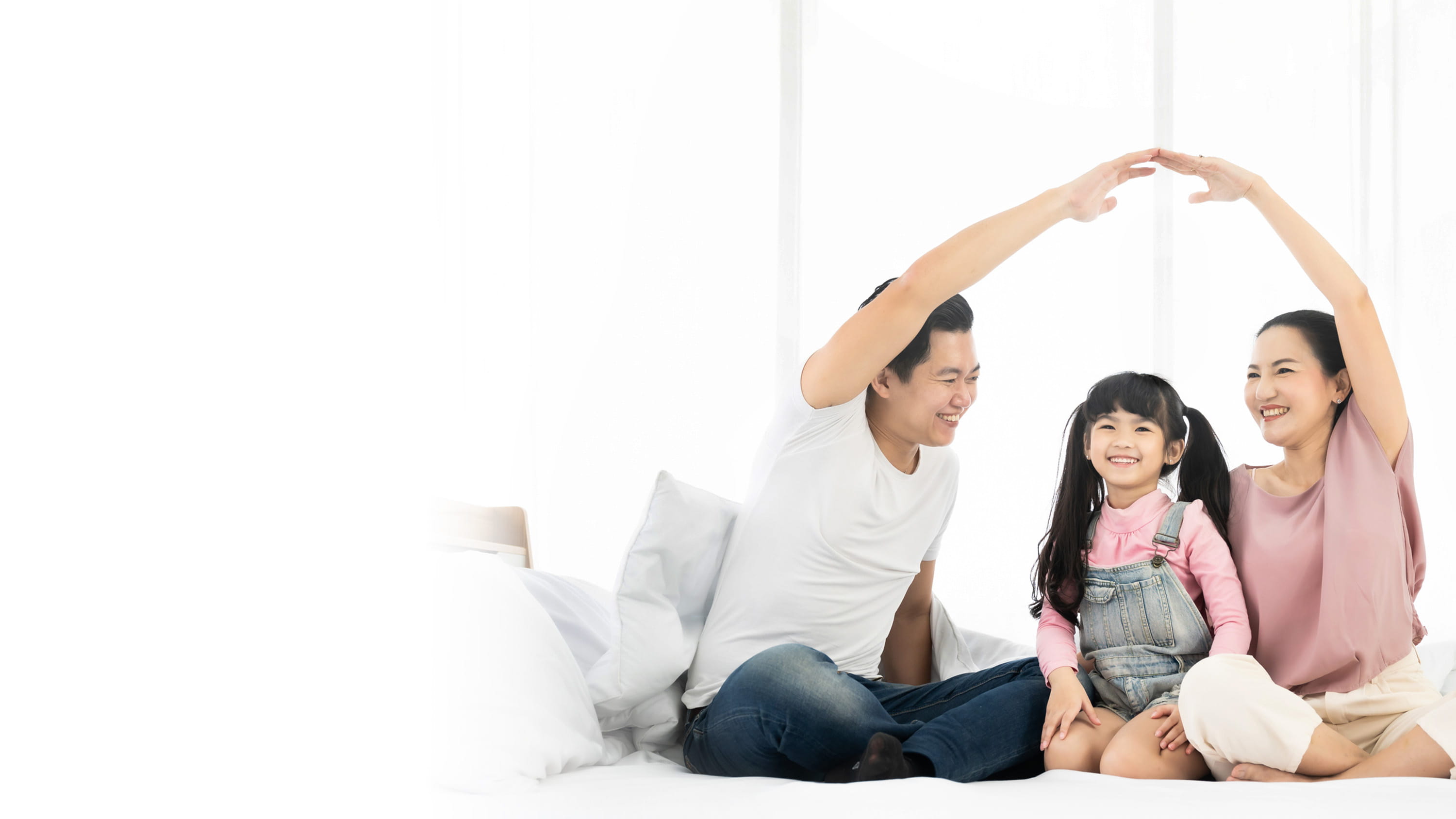Parents playing with their young daughter at home.