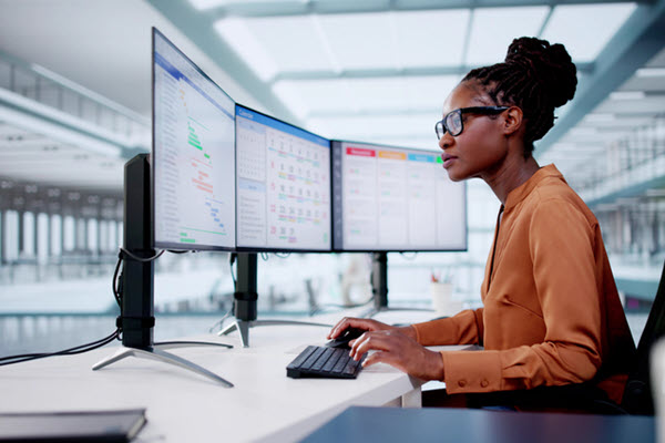 Woman looking at multiple screens