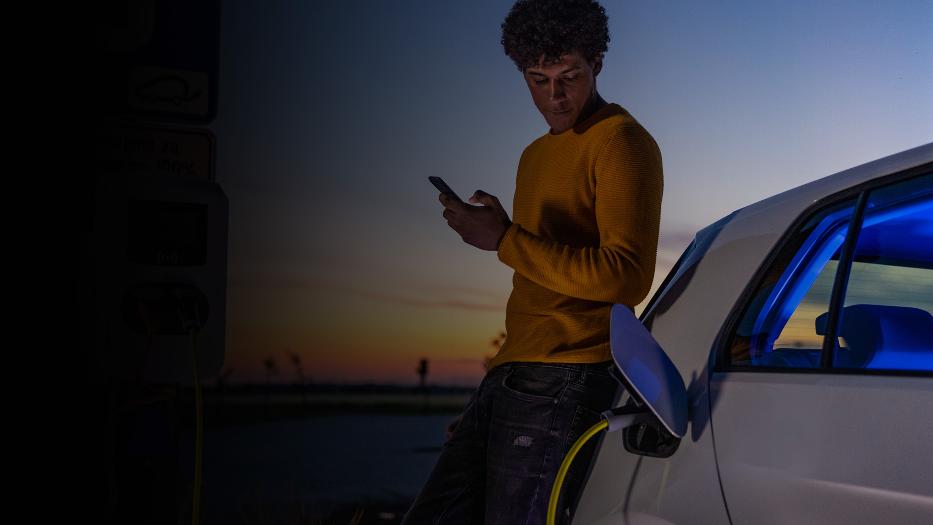 A man charging his electric vehicle.