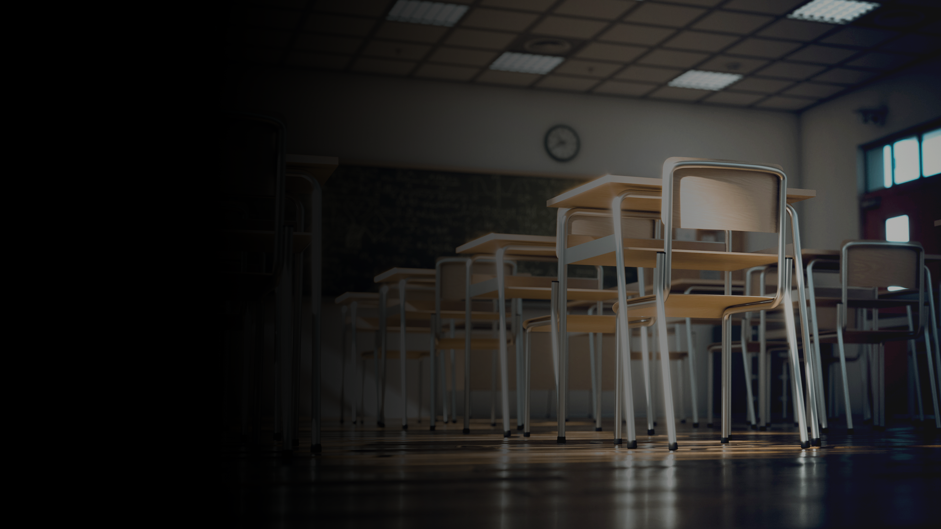 An empty classroom full of desks and chairs.