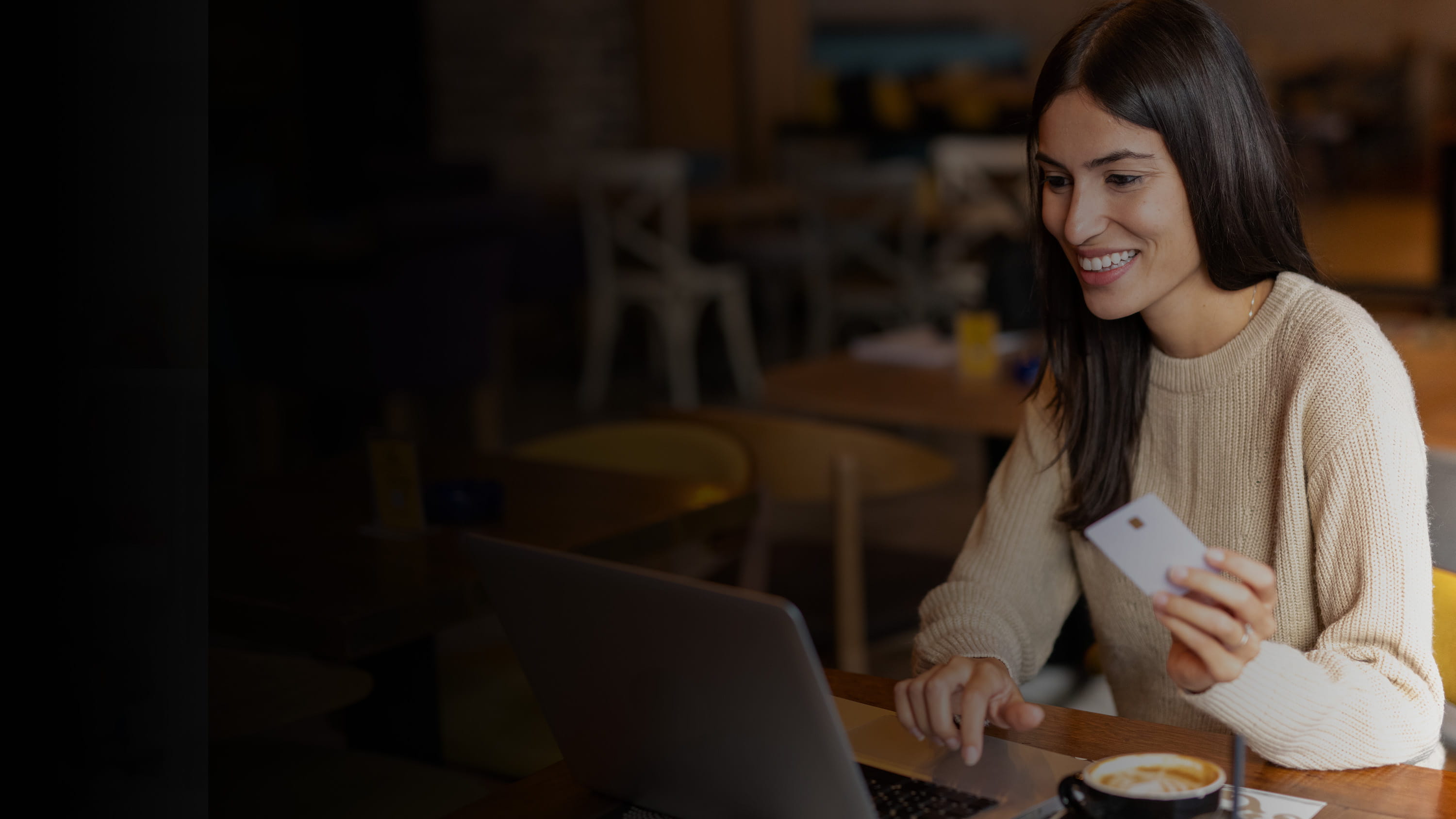 A woman using a credit card to shop online.