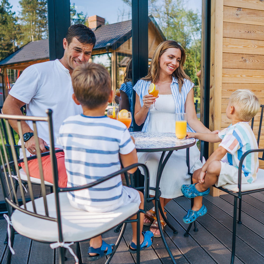 A family sitting on a deck.