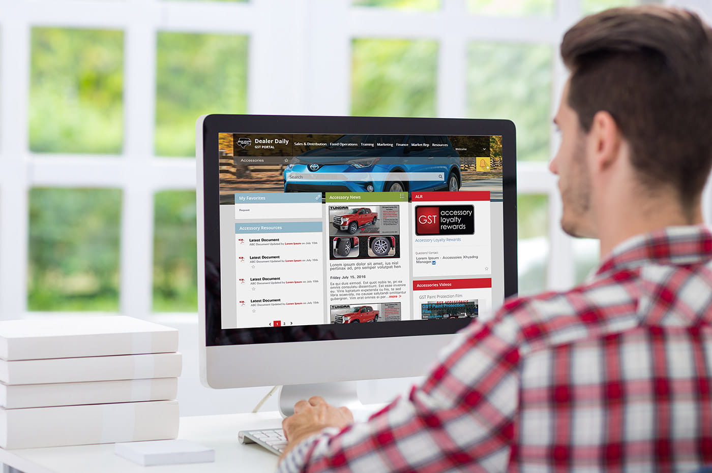 A man looking at a Gulf States Toyota website page on a desktop computer.