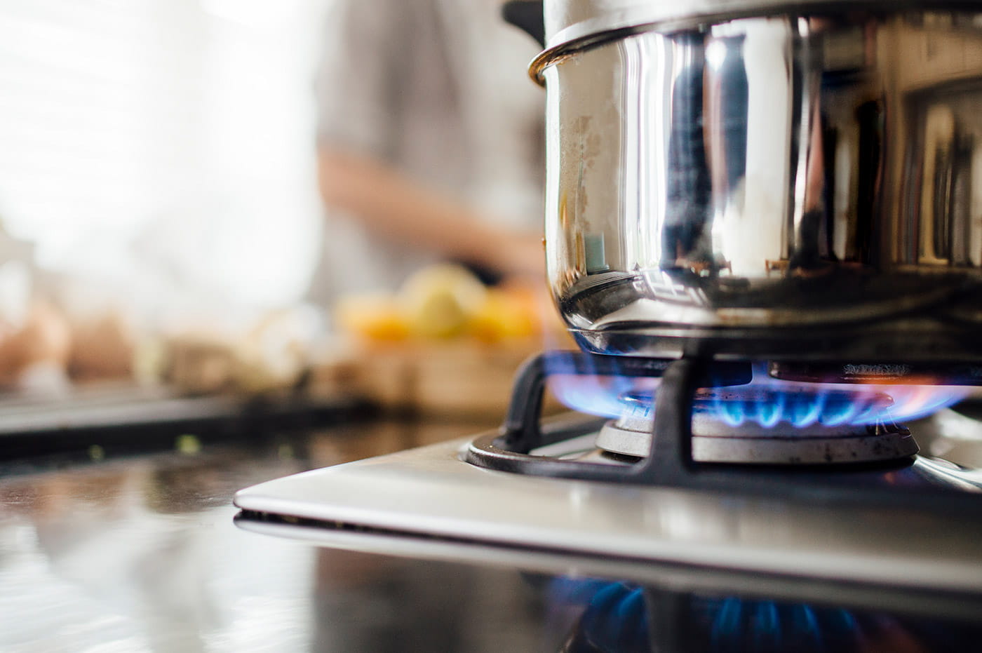 Pot cooking on an oven over flame.