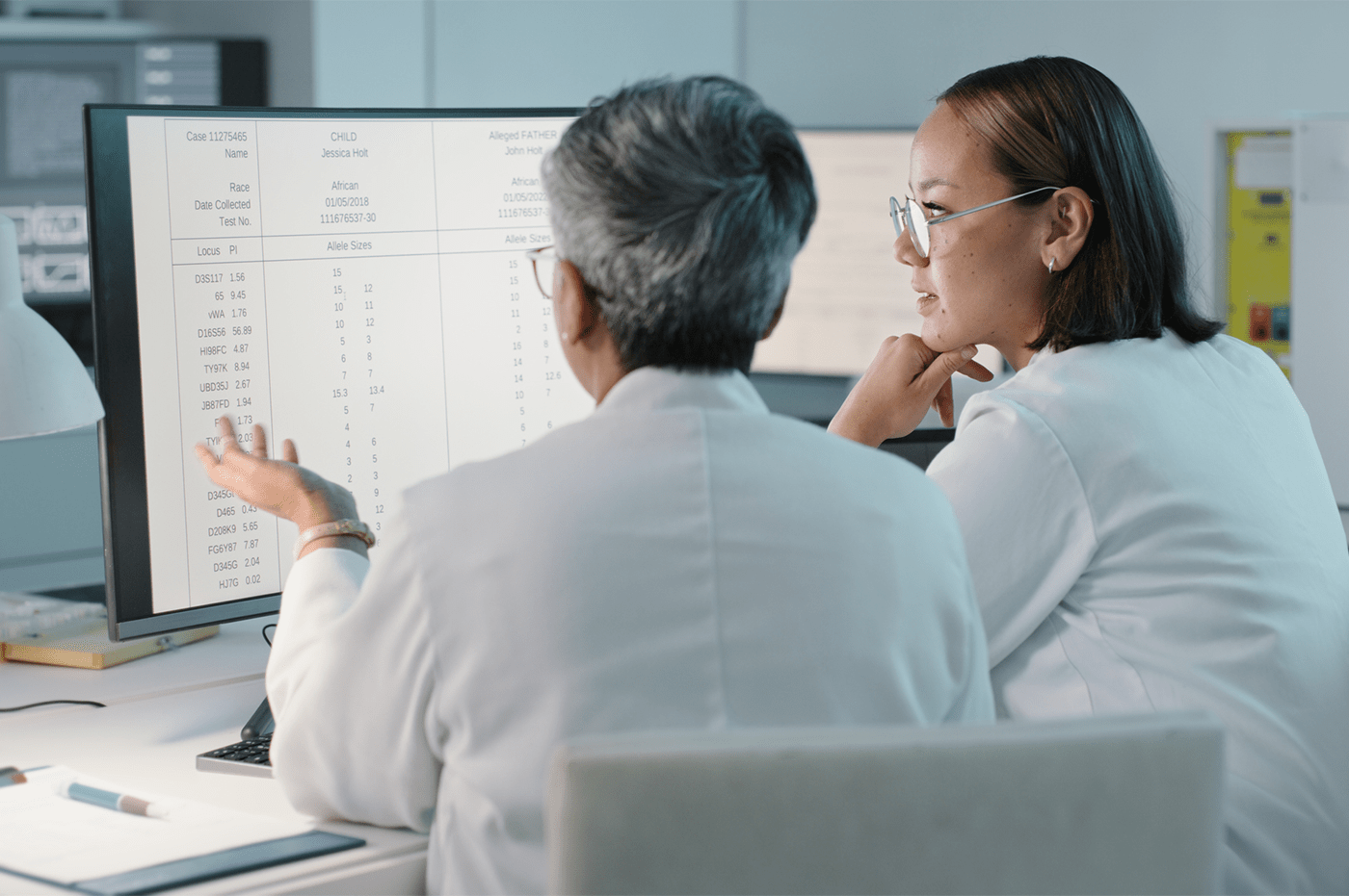 Two doctors looking over something on a computer screen. 