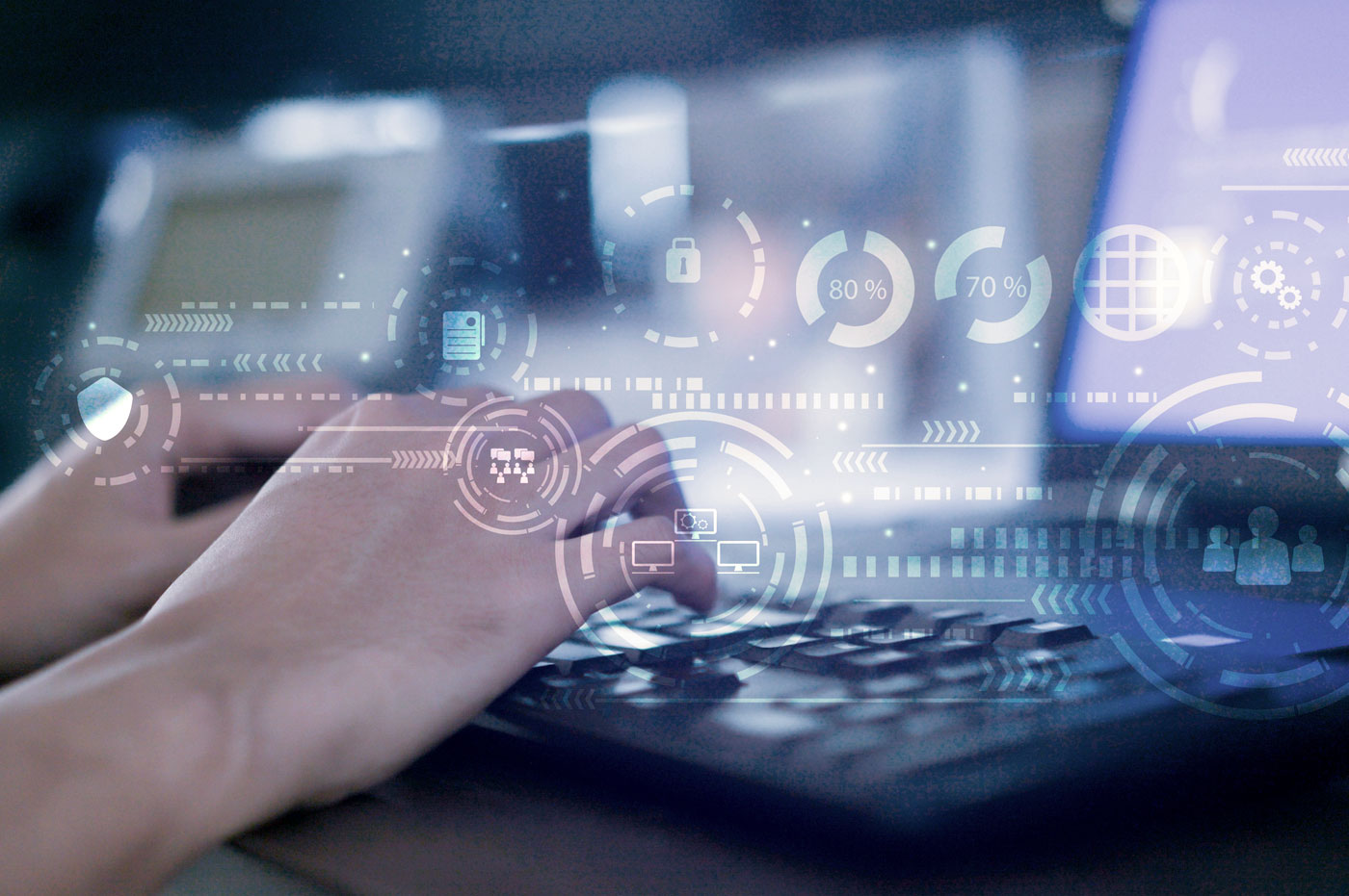 A pair of hands working on a computer with glowing technology symbols superimposed on it.
