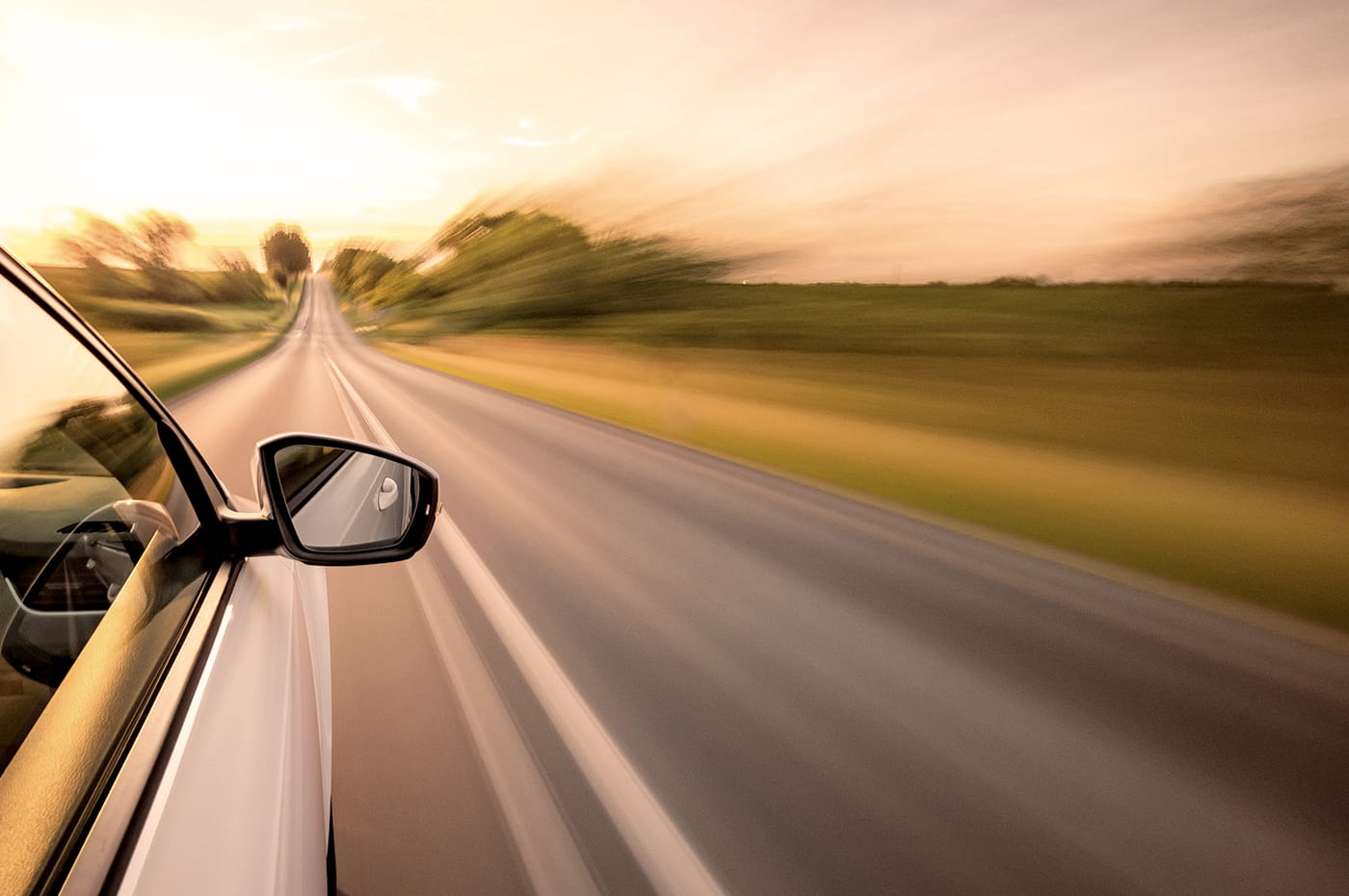 A car driving fast down a road.