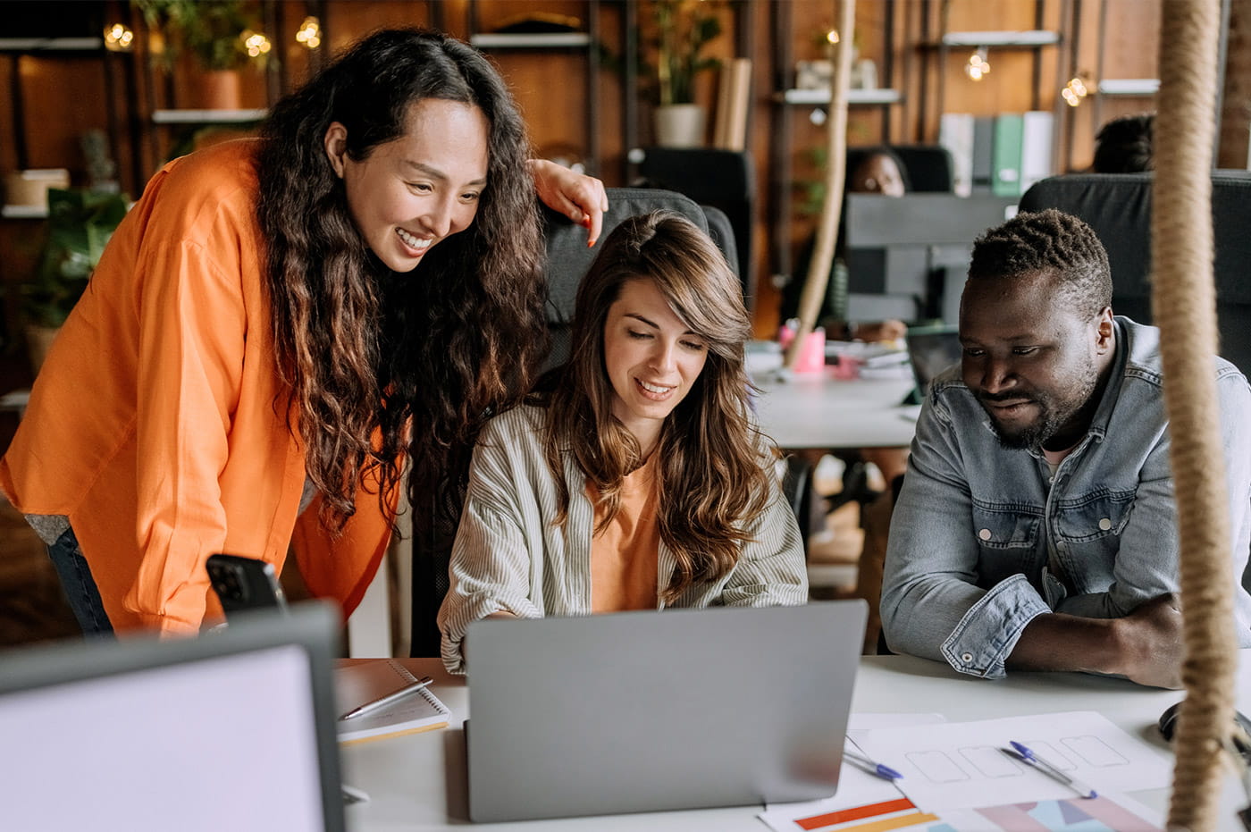 Three colleagues working on a project together.