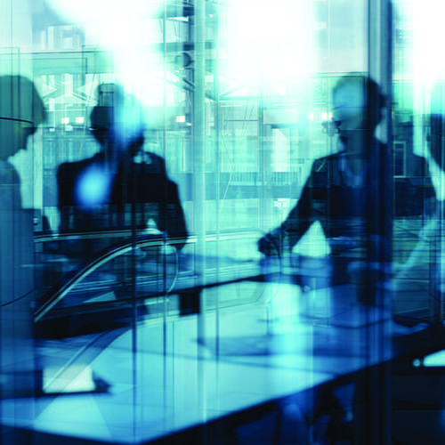 A group of professionals sitting in a meeting.