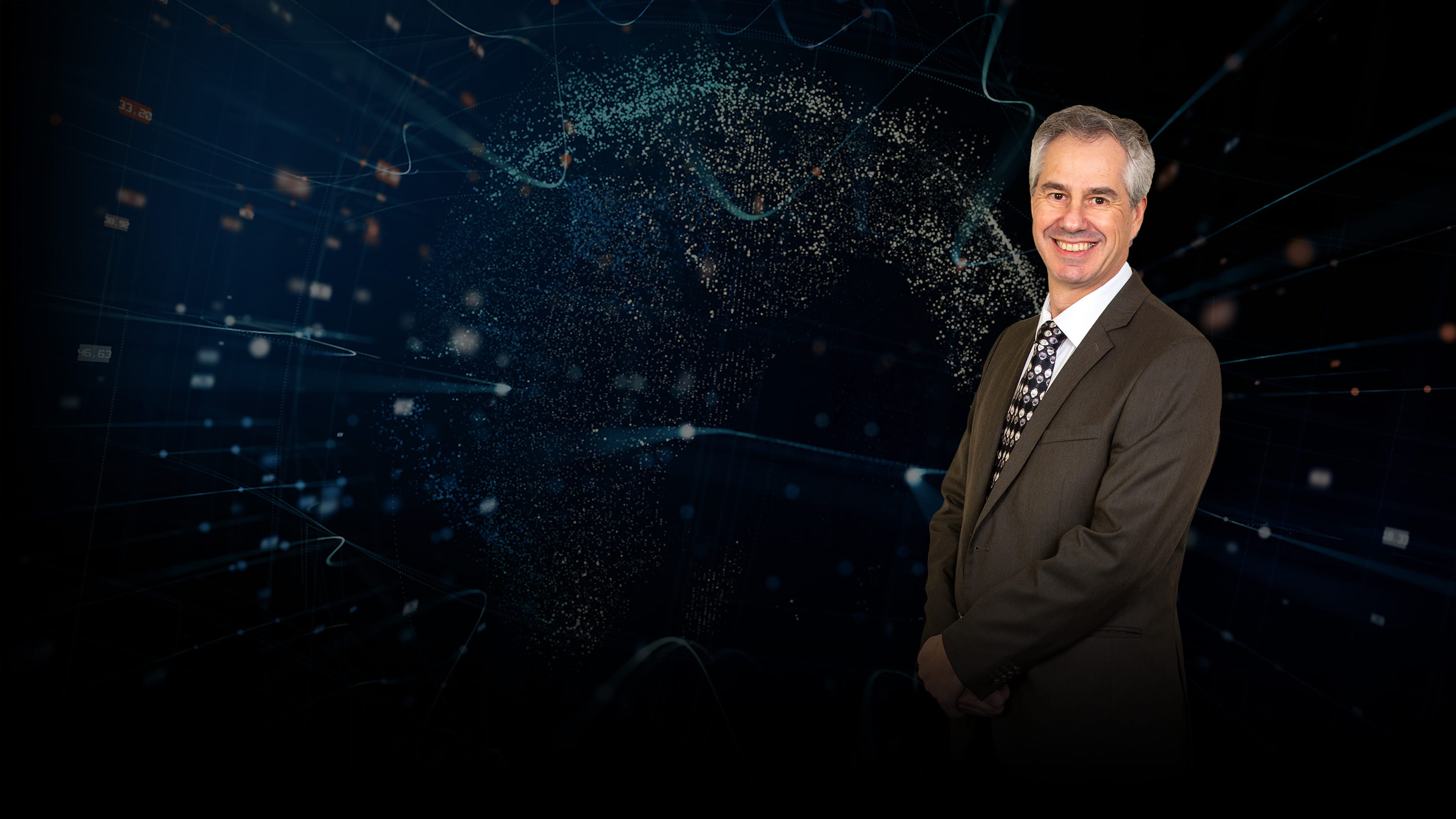 Glenn Kline in front of an abstract background