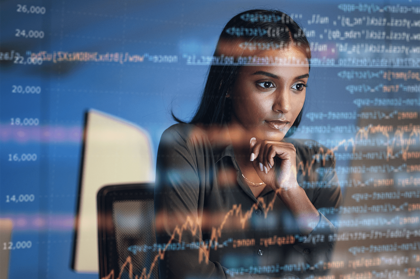 Young woman deep in thought and coding.