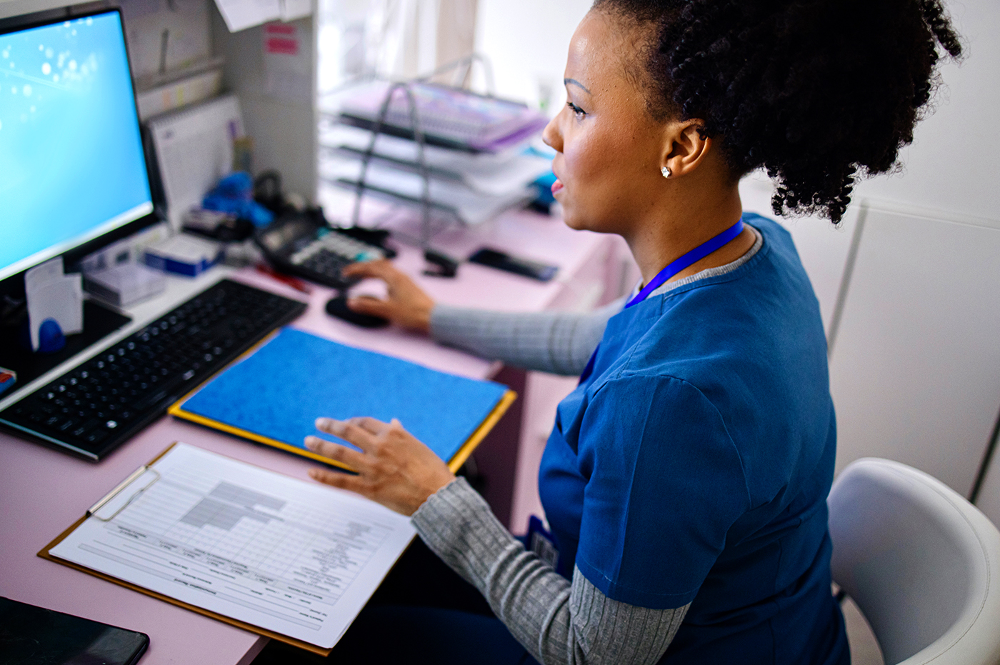A healthcare worker on her computer.