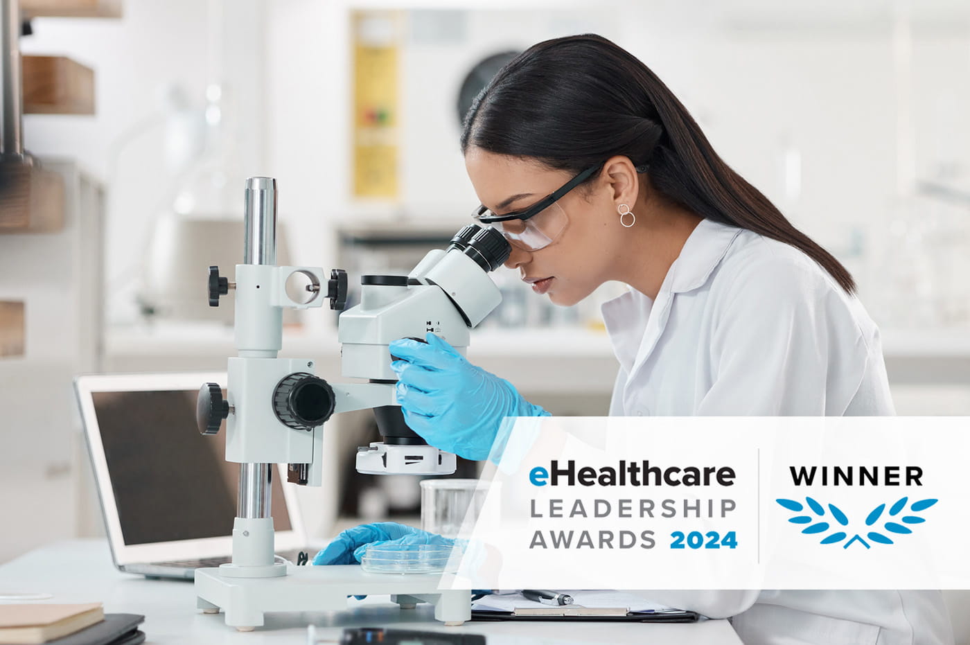 A medical professional looking through a microscope. eHealthcare Leadership Awards winner.