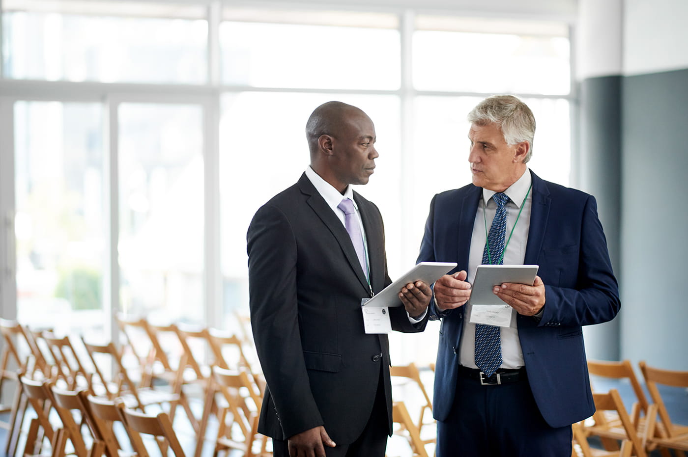 Two businessmen in suits talking.