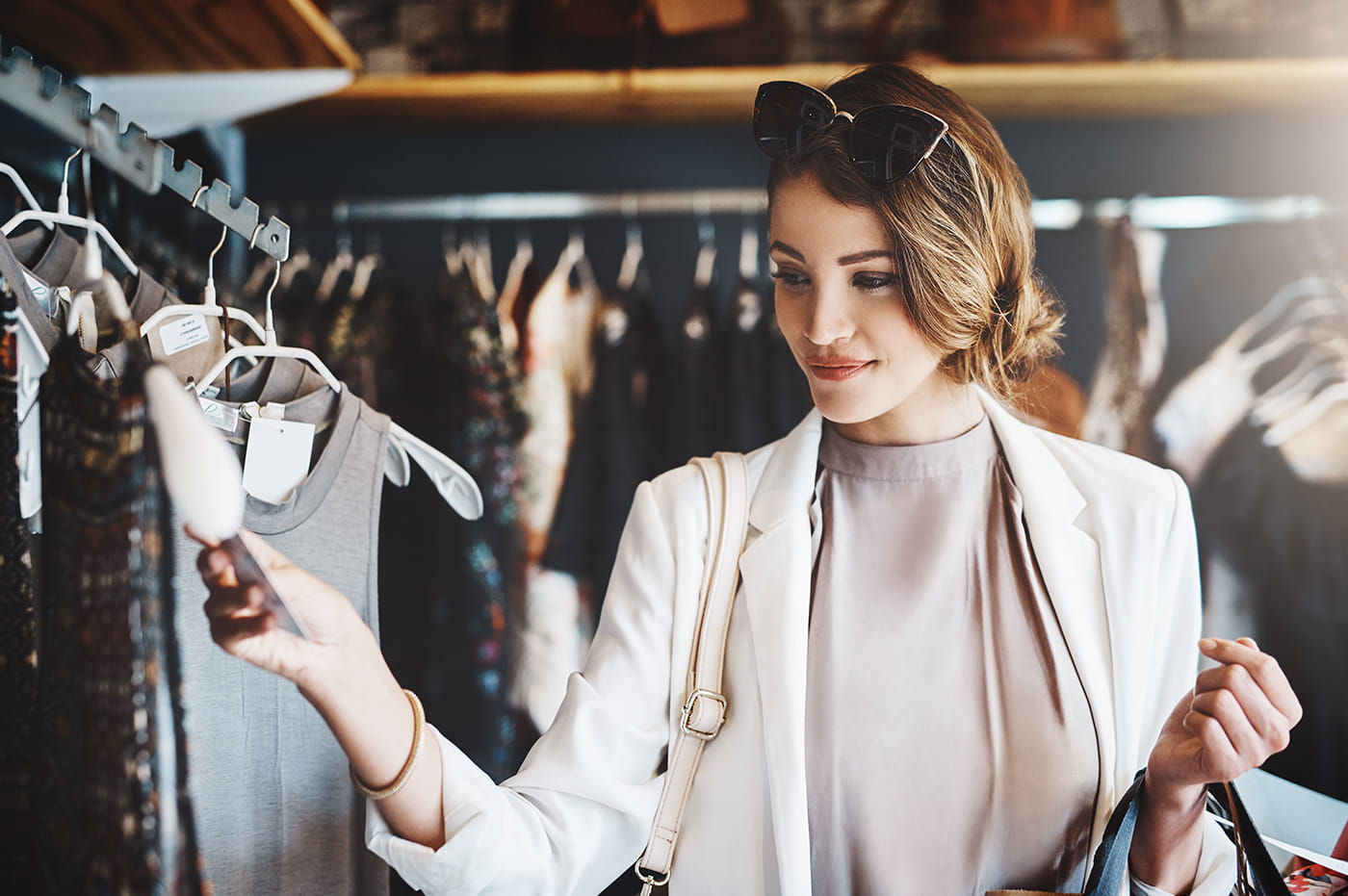 Woman browsing through different clothes in a clothing store.